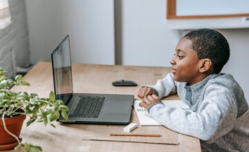 Graduate holding diploma representing student loans